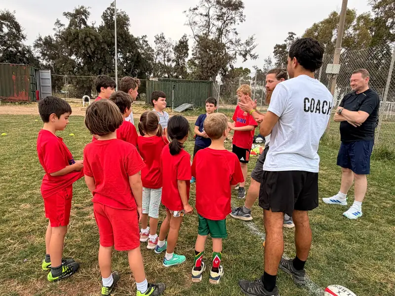 Coach talking to a group of young players