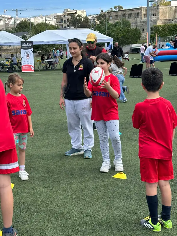 Young player practising ball skills with a coach