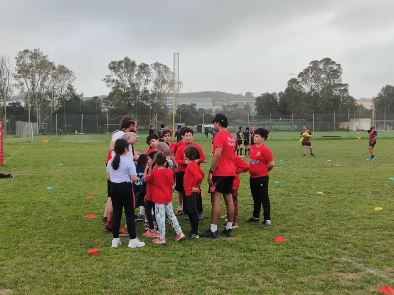 Youth players gathered together on the pitch